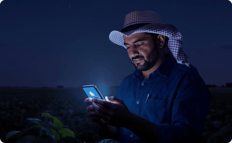 Farmer using a phone in a field